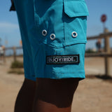 HIC ENJOY THE RIDE Generals Boardshorts in blue with floral pattern, displayed on a hanger against a neutral background.